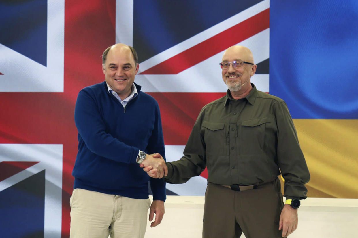 British Defence Minister Ben Wallace, left, shakes hands with Ukrainian Minister of Defense Oleksii Reznikov during his visit to Kyiv, Ukraine, Wednesday, May 24, 2023. (Ukrainian Defense Ministry Press Office via AP)