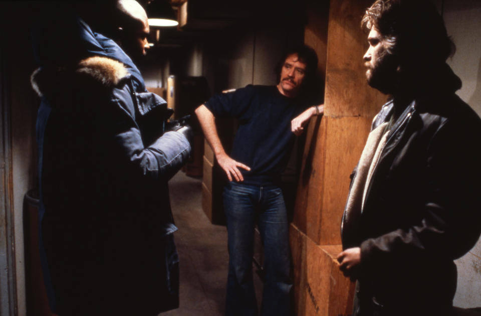 Keith David, John Carpenter and Kurt Russell stand talking to one another