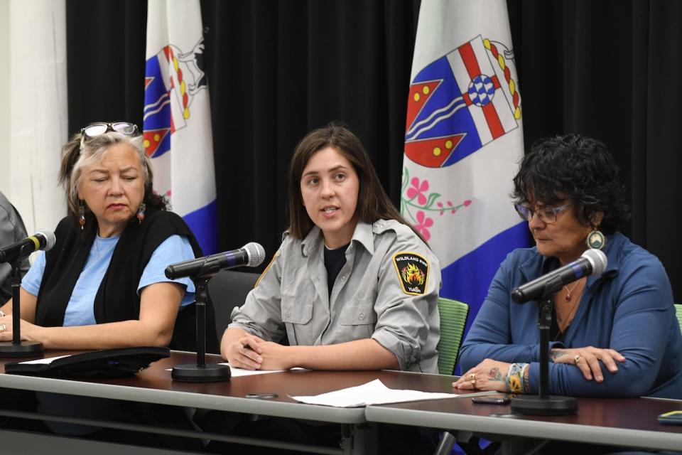 Yukon Health and Social Services Minister Tracy-Anne McPhee, left, fire information officer Haley Ritchie, centre, and Na-Cho Nyak Dun Chief Dawna Hope speak a t a wildfire news conference in Whitehorse, Aug. 10, 2023.