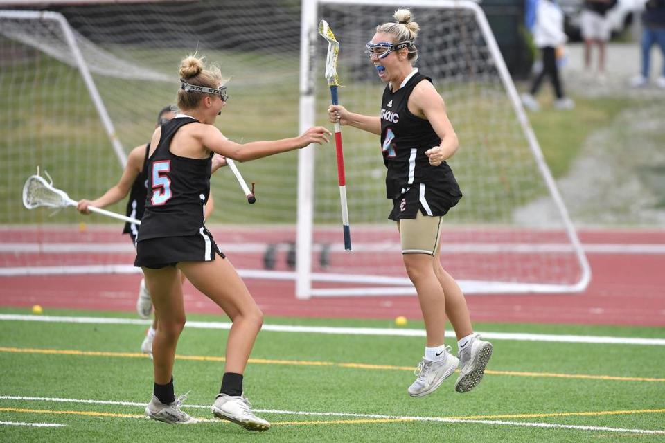 Charlotte Catholic’s Mary Catherine Farley (5) celebrates with Jenna Thompson (4) after her goal during the first half. The Charlotte Catholic Cougars and the Cardinal Gibbons Crusaders met in the NCHSAA 4A Girls Lacrosse Final in Durham , NC on May 19, 2023.