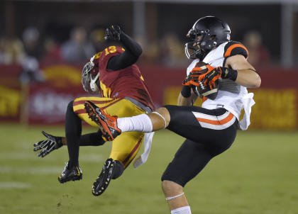 Oregon State wide receiver Richard Mullaney, right, catches a pass as Southern California cornerback Kevon Seymour defends during the first half of an NCAA college football game, Saturday, Sept. 27, 2014, in Los Angeles. (AP Photo/Mark J. Terrill)