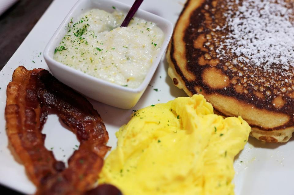 Tulua Bistro's “Springfield Platter” features two scrambled eggs, two bacon strips, grits and pancakes.