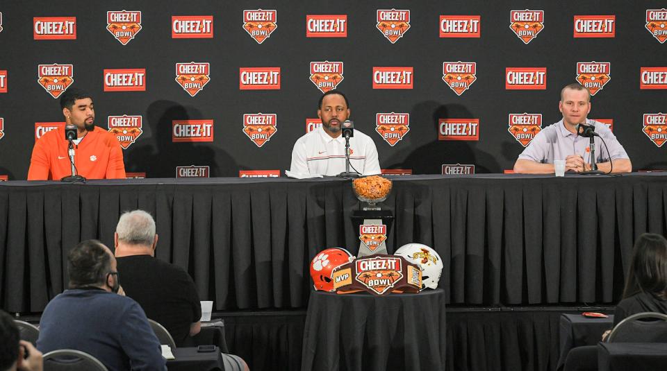 Clemson quarterback D.J. Uiagalelei, left, special teams coordinator Mike Reed, and  offensive coordinator Brandon Streeter during the 2021 Cheez-It Bowl press conference at the Rosen Plaza in Orlando, Florida Sunday, December 26, 2021. 