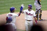 Philadelphia Phillies' Matt Vierling, right, high fives Jean Segura after Vierling hit a solo home run off Pittsburgh Pirates starting pitcher Wil Crowe during the third inning of a baseball game, Saturday, Sept. 25, 2021, in Philadelphia. (AP Photo/Derik Hamilton)