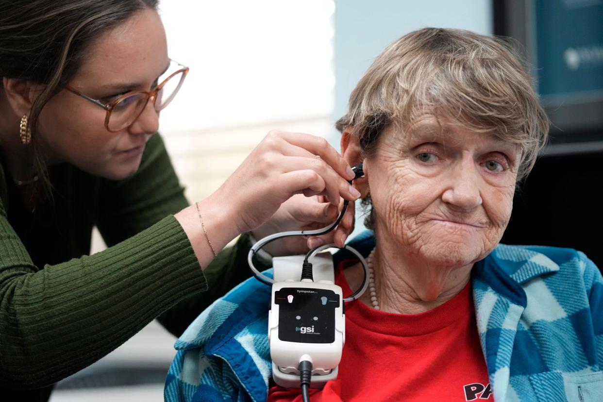 Dr. Kailey Murphy measures the pressure inside Sue Smith's ears as she fits Smith for hearing aids at Hearing and Brain Centers of America last month.