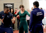 Britain's Catherine, Duchess of Cambridge (C), is shown Taekwondo moves by Britain's Lutalo Muhammad (L) during a SportsAid event at the London Stadium in east London on February 26, 2020. (Photo by Yui Mok / POOL / AFP) (Photo by YUI MOK/POOL/AFP via Getty Images)