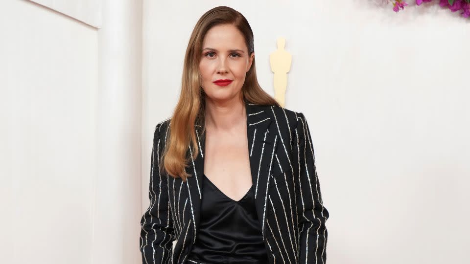 Justine Triet, who later picked up the Best Original Screenplay Oscar for “Anatomy of a Fall,” wore a sparkly striped Louis Vuitton suit with a satin top and black pumps. - Jordan Strauss/Invision/AP