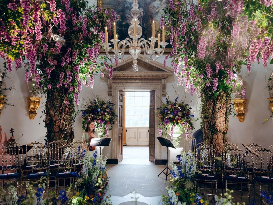 A picture of a white room filled with flowers.