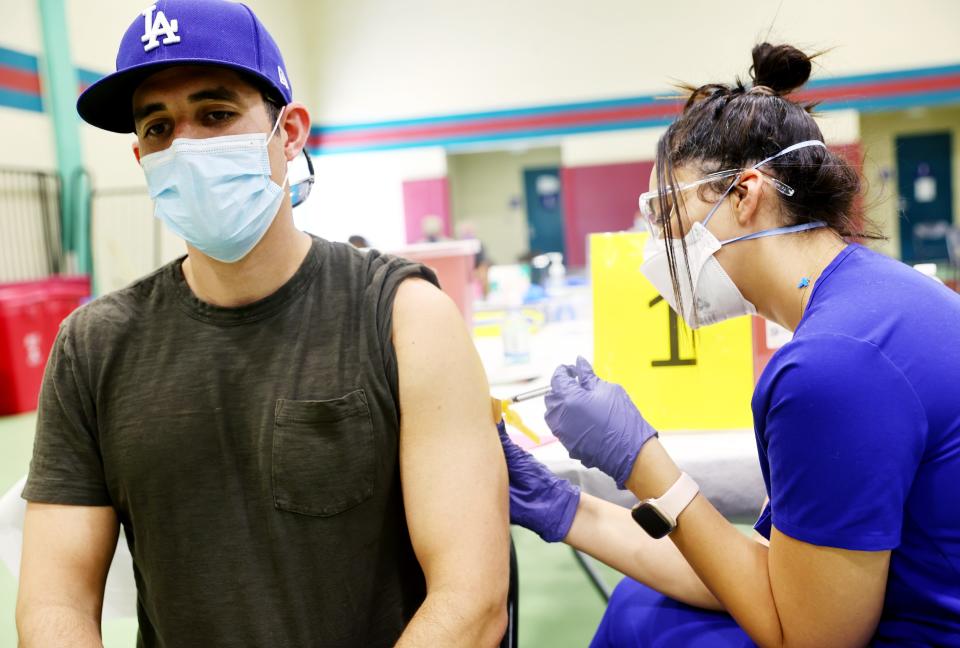 Licensed vocational nurse Yustina Mikhael, right, administers a dose of the Jynneos monkeypox vaccine in Los Angeles earlier this month.