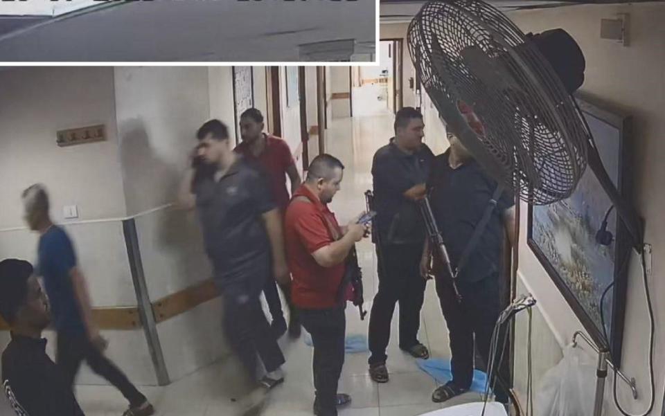 Hamas terrorists outside a room in Al Shifa hospital where a hostage was taken into