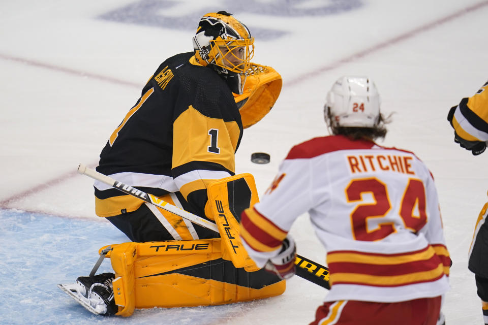 Pittsburgh Penguins goaltender Casey DeSmith (1) watches a rebound during the first period of the team's NHL hockey game against the Calgary Flames in Pittsburgh, Thursday, Oct. 28, 2021. (AP Photo/Gene J. Puskar)
