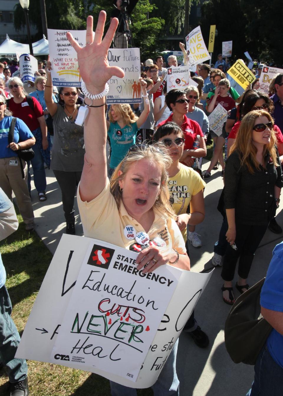 FILE -- In this May 13, 2011 file photo, Lesslie Corner, a teacher from Amador County, joined more than 2,000 other teachers, students and supporters in a demonstration against proposed budget cuts to education at the Capitol in Sacramento, Calif. If approved by voters in November, Proposition 32 would prohibit corporations and unions, like the California Teachers Association, from collecting money for state political activities from employees or members through paycheck deductions. It also prohibits unions and corporations from making donations to state candidates.(AP Photo/Rich Pedroncelli, File)