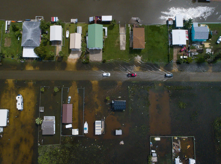 Cars drive on a flooded street in Sargent, Texas, as seen in this aerial photo, Sept. 18, 2019. (Photo: Mark Mulligan/Houston Chronicle via AP)