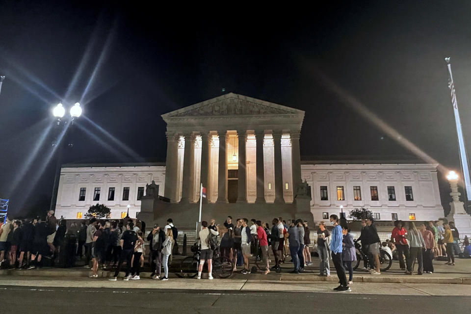 A crowd of people gather outside the Supreme Court, Monday night, May 2, 2002 in Washington. / Credit: Anna Johnson / AP