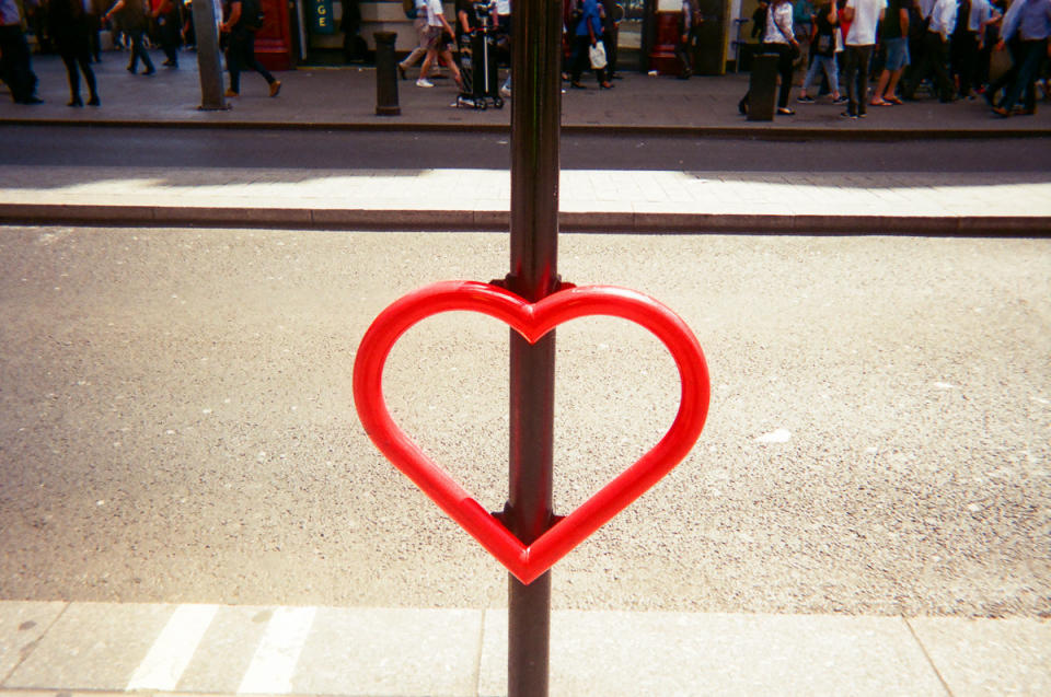 A street sign is decorated with a big love heart. (Cafe Art/SWNS)