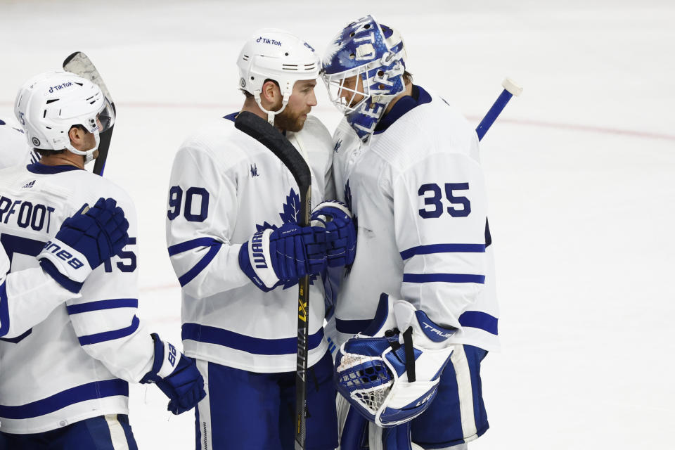 Toronto Maple Leafs center Ryan O'Reilly (90) and goaltender Ilya Samsonov (35) celebrate a 6-3 victory over the Buffalo Sabres following the third period of an NHL hockey game, Tuesday, Feb. 21, 2023, in Buffalo, N.Y. (AP Photo/Jeffrey T. Barnes)