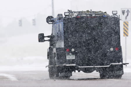 An armored vehicle drives down a road leading to a Planned Parenthood center after reports of an active shooter in Colorado Springs, November 27, 2015. REUTERS/Isaiah J. Downing