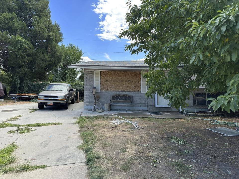 This photo shows a boarded up window at the home of Craig Robertson, Thursday, Aug 10, 2023, in Provo, Utah. Robertson was killed by FBI agents Wednesday during a confrontation after making violent threats against President Joseph Biden and other public officials. (AP Photo/Sam Metz)