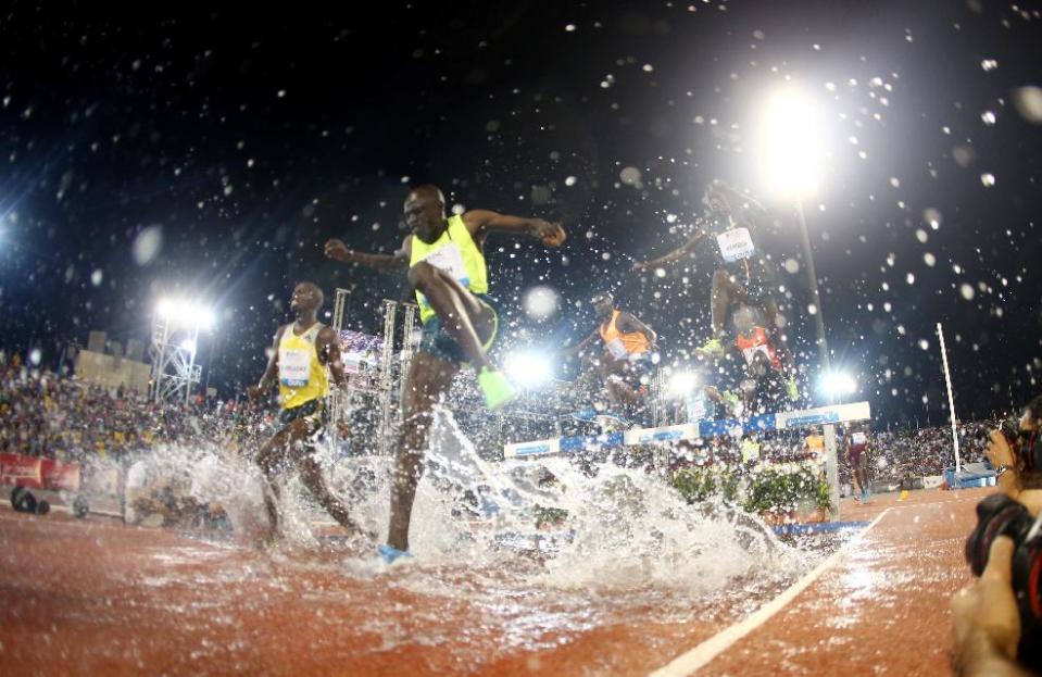 Athletes compete in the men's 3,000m steeplechase at the IAAF Diamond League in the Qatari capital Doha, Friday May 9, 2014. (AP Photo/Osama Faisal)
