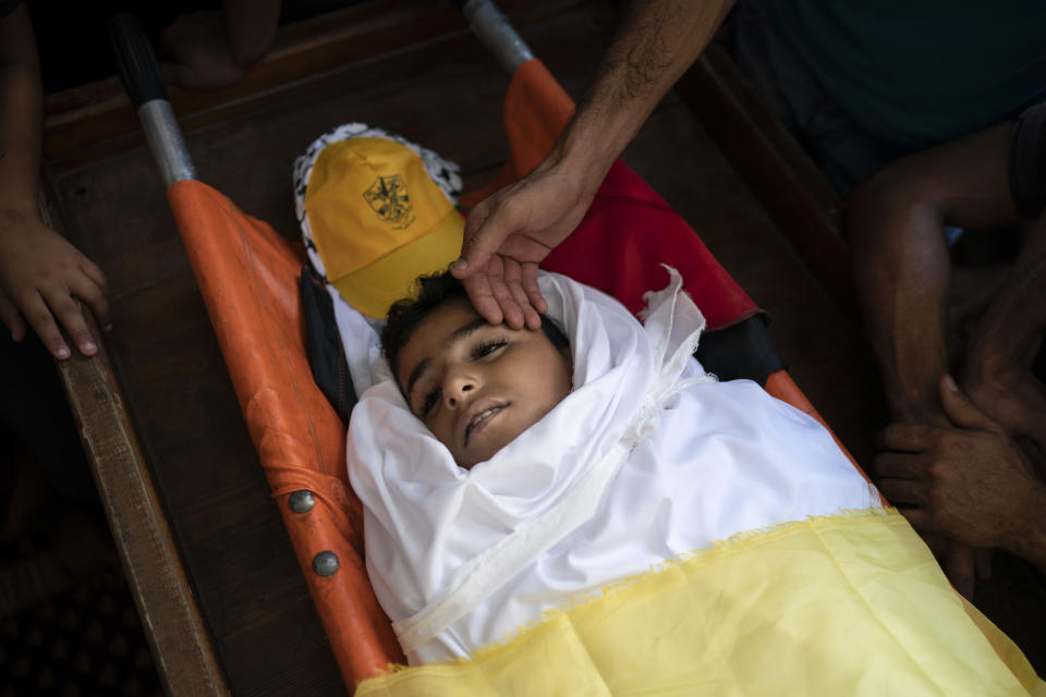 Palestinians mourn over the body of 11-year-old Shady Abdel-al during his funeral in Beit Lahiya, northern Gaza Strip Sept. 15, 2018. Though the Health Ministry initially reported Abdel-al was shot by Israeli fire, the Israeli army claimed he was accidentally struck by a rock thrown by protesters. Two Gaza rights groups say he died after being hit "with a solid object." (AP Photo/Felipe Dana)