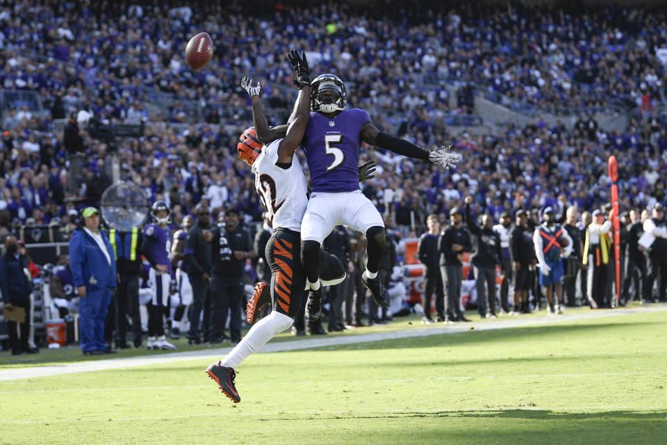 Baltimore Ravens wide receiver Marquise Brown (5) goes up to try to catch a pass as Cincinnati Bengals cornerback Chidobe Awuzie defends during the second half of an NFL football game, Sunday, Oct. 24, 2021, in Baltimore. (AP Photo/Nick Wass)