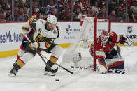 Vegas Golden Knights center William Karlsson (71) skates with the puck as Florida Panthers defenseman Josh Mahura defends during the first period of Game 3 of the NHL hockey Stanley Cup Finals, Thursday, June 8, 2023, in Sunrise, Fla. (AP Photo/Lynne Sladky)