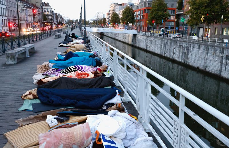 Asylum seekers sleep on a street in central Brussels