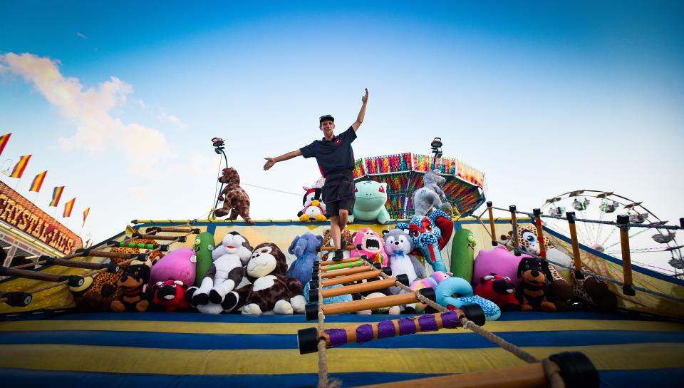 Stephen "Stimpy" Stimpson, II, 26, of Bangor, Maine, demonstrates his "Jacob's Ladder" carnival game Tuesday, July 13, 2022, at the Eaton County Fair in Charlotte.