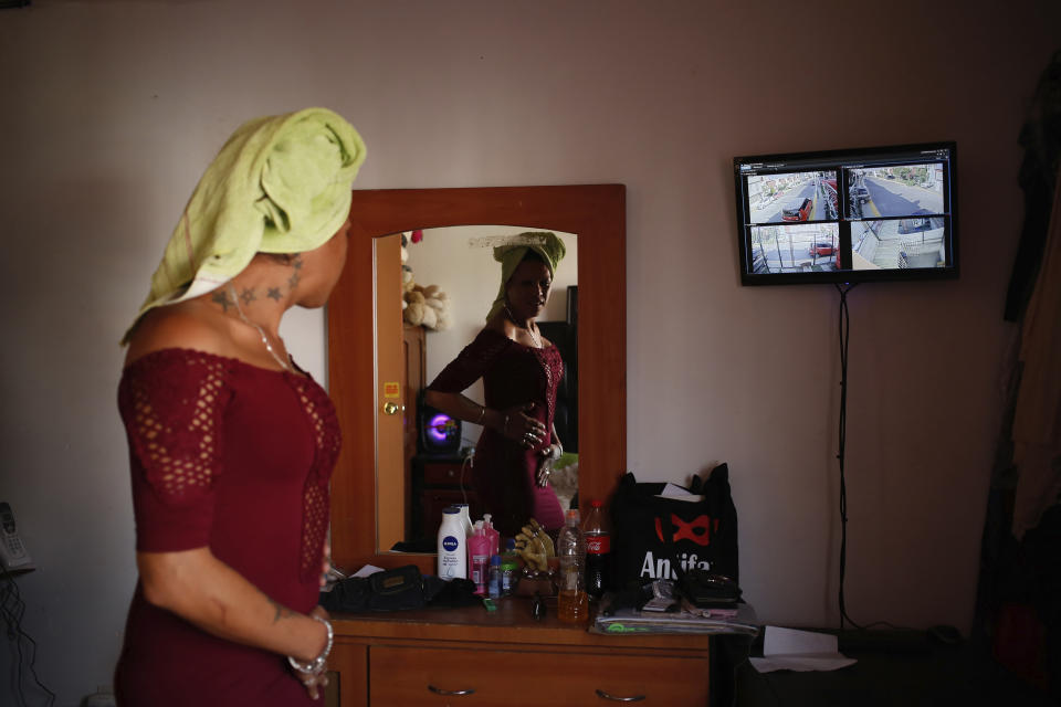 In this Aug. 17, 2019 photo, and LCD monitors displays images from a home security camera system as trans rights activist Kenya Cuevas prepares to go out, in Chalco, Mexico. Mexico has become the world's second deadliest country after Brazil for transgender people. (AP Photo/Ginnette Riquelme)