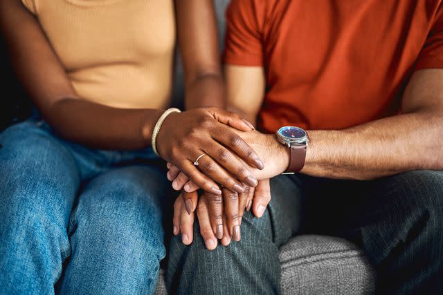 <p>Getty</p> Stock image of a couple holding hands.