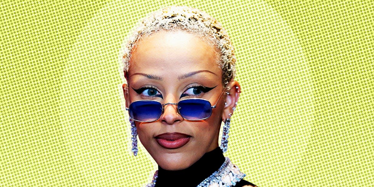 Doja Cat, an American rapper, singer, songwriter, and record producer on a light green patterned background