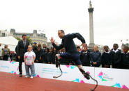 LONDON, ENGLAND - SEPTEMBER 8: Oscar Pistorius shows off his skills as Chairman of LOCOG Lord Coe and Ellie Simmonds look on during the International Paralympic Day at Trafalgar Square on September 8, 2011 in London, England. The day marks the start of Paralympic tickets going on sale on September 9, 2011. (Photo by Jan Kruger/Getty Images)