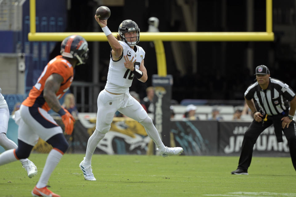 Jacksonville Jaguars quarterback Trevor Lawrence, right, throws a pass against the Denver Broncos during the first half of an NFL football game, Sunday, Sept. 19, 2021, in Jacksonville, Fla. (AP Photo/Phelan M. Ebenhack)