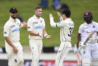 New Zealand's Tim Southee, second left, is congratulated by teammates after dismissing the West Indies' John Campbell during play on day three of their first cricket test in Hamilton, New Zealand, Saturday, Dec. 5, 2020. (Andrew Cornaga/Photosport via AP)