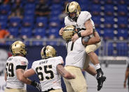 Army quarterback Cade Ballard, right, celebrates a touchdown with teammates Jordyn Law, Noah Knapp (65) and Mike Johnson (59) during an NCAA college football game against UTSA on Saturday, Oct. 17, 2020, in San Antonio, Texas. Army won 28-16. (AP Photo/Darren Abate)