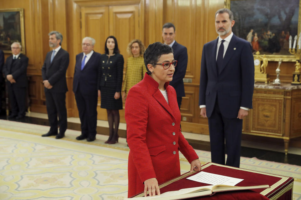 Arancha Gonzalez Laya takes her oath of office as Spain's new foreign minister during the swearing in ceremony at the Zarzuela Palace just outside of Madrid, Spain, Monday Jan. 13, 2020. A total of 22 ministers have taken their oaths in Spain's center to far left-wing coalition administration, a first in a country once dominated by two main parties taking turns in power.(Chema Moya/ Pool Photo via AP)