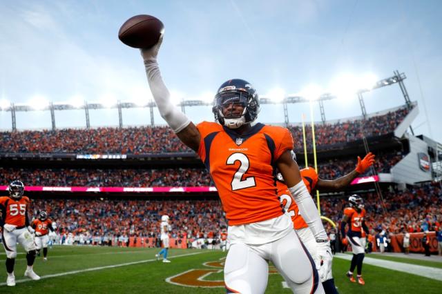 DENVER, CO - OCTOBER 31: Denver Broncos cornerback Pat Surtain II (2) and  free safety Justin Simmons (31) look on as an injured player is tended to  during a game between the