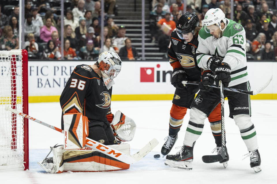 Anaheim Ducks goaltender John Gibson (36) blocks a shot in front of Dallas Stars right wing Evgenii Dadonov (63) during the second period of an NHL hockey game, Thursday, Oct. 19, 2023, in Anaheim, Calif. (AP Photo/Kyusung Gong)