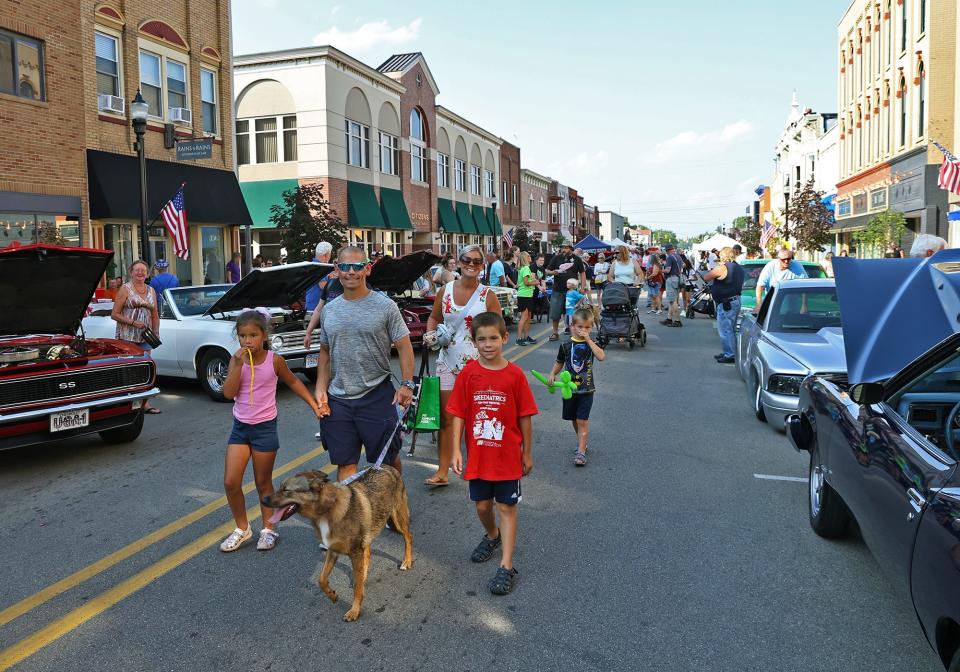 The Dog Days of Summer pet parade proceeds through downtown Adrian Friday, Aug. 4, 2023, during First Fridays.