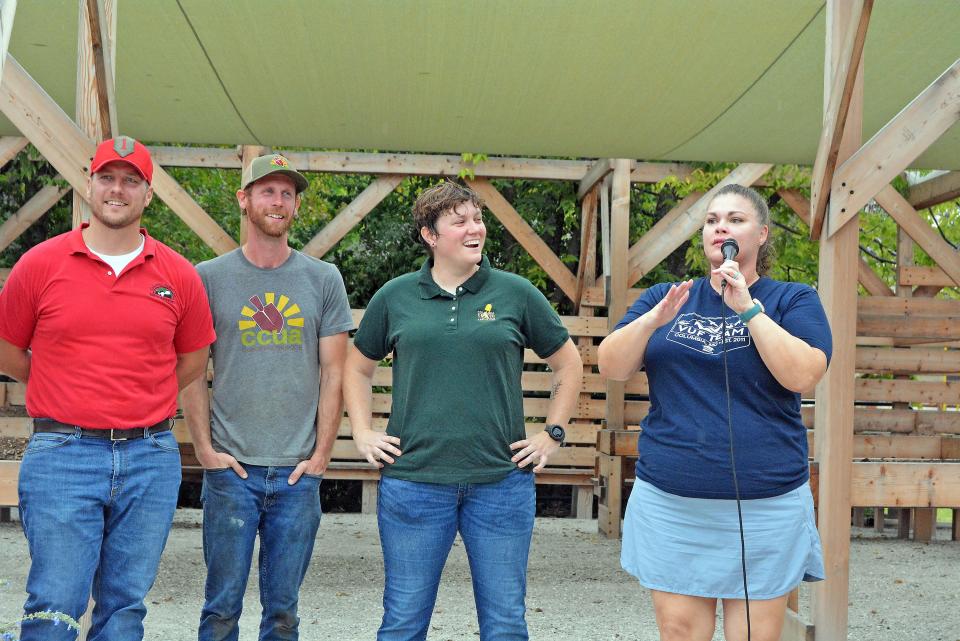 Piper Brintnall, right, Veterans United Foundation outreach coordinator, on Wednesday shares how a grant program two years ago led to the opening of the accessible Warriors Garden from Columbia Center for Urban Agriculture, while joined by CCUA staff Billy Froeschner, from left, Joe Walls and Crystal Wiggins.