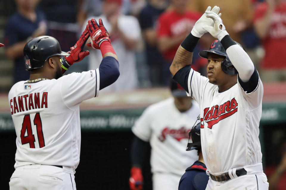 Cleveland Indians' Jose Ramirez, right, is congratulated by Carlos Santana after hitting a three-run home run in the third inning of a baseball game against the Boston Red Sox, Monday, Aug. 12, 2019, in Cleveland. (AP Photo/Tony Dejak)