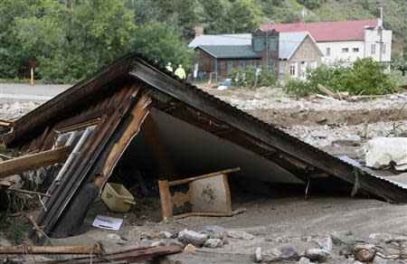 A chair lies under a destroyed house in Jamestown, Colorado, after a flash flood destroyed much of the town, September 14, 2013. REUTERS/Rick Wilking