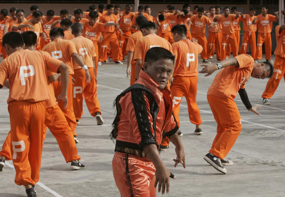 FILE - In this June 27, 2009 file photo, inmates at the Cebu Provincial Detention and Rehabilitation Center on the island province of Cebu in central Philippines dance to the late Michael Jackson's "We Are The World" to pay tribute to the music icon. The Filipino inmates whose choreographed "Thriller" dance has attracted 52 million YouTube hits since 2007 are getting their own stories told in a movie. Director Marnie Manicad says the action drama "Dance of the Steel Bars" was shot in the Cebu provincial prison, the same place where the inmates dressed in orange uniforms danced to global fame. Manicad co-directed the movie with Cesar Apolinario. It will be released in June, 2013. (AP Photo/Bullit Marquez, File)