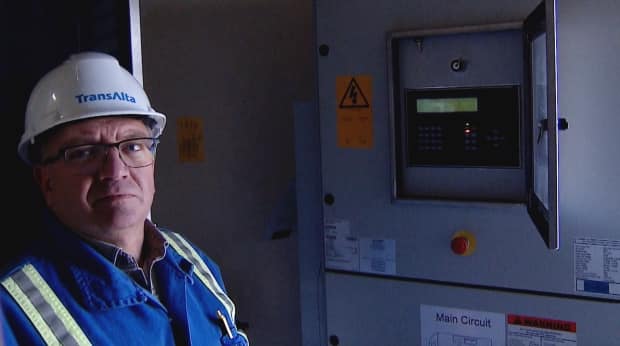 Inside a wind turbine, TransAlta's Wayne Oliver checks to see how much power is being produced.