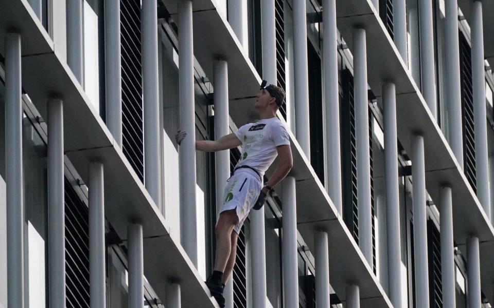 George King used nothing but his bare hands to climb the residential block in Stratford on Tuesday morning  - Yui Mok/PA 