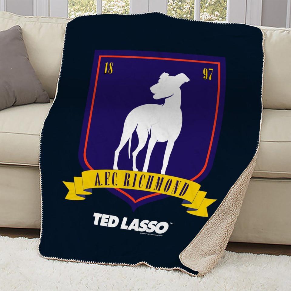 <p><strong>Ted Lasso</strong></p><p>wbshop.com</p><p><strong>$69.95</strong></p><p><a href="https://wbshop.com/collections/ted-lasso/products/ted-lasso-a-f-c-richmond-crest-sherpa-blanket" rel="nofollow noopener" target="_blank" data-ylk="slk:Shop Now;elm:context_link;itc:0;sec:content-canvas" class="link ">Shop Now</a></p>