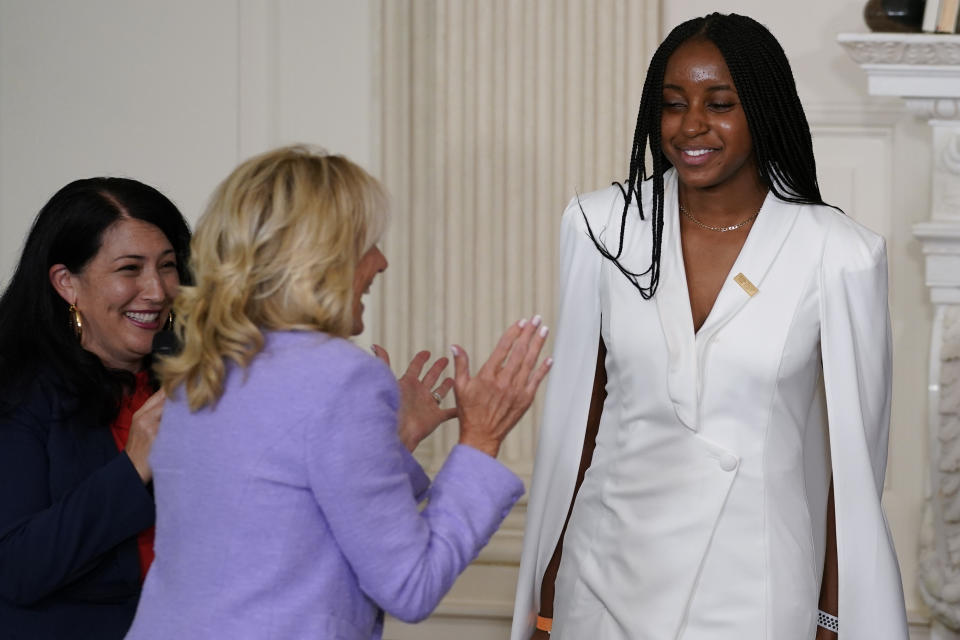 First lady Jill Biden and Ada Limón, 24th Poet Laureate of the United States, left, applaud Emily Igwike, from Milwaukee, right, during an event for the Class of 2022 National Student Poets at the White House in Washington Tuesday, Sept. 27, 2022. (AP Photo/Carolyn Kaster)