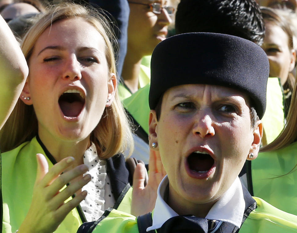 ALTERNATE CROP TO PFRA110 - Lufthansa cabin crew members gather for a demonstration as flight attendants of German Lufthansa airline went on an 24-hour-strike for higher wages at the airport in Frankfurt, Germany, Friday, Sept. 7, 2012. Lufthansa canceled 1200 flights. (AP Photo/Michael Probst)