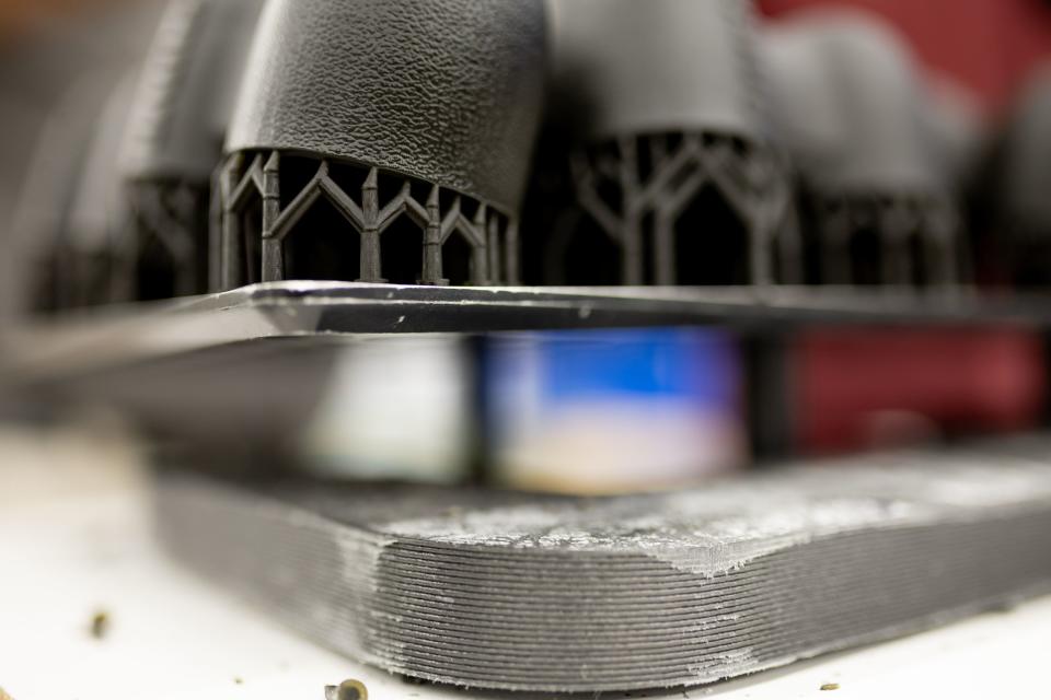 Parts that were printed using additive manufacturing techniques await finishing at Merit3D in Price on Thursday, Aug. 17, 2023. | Spenser Heaps, Deseret News