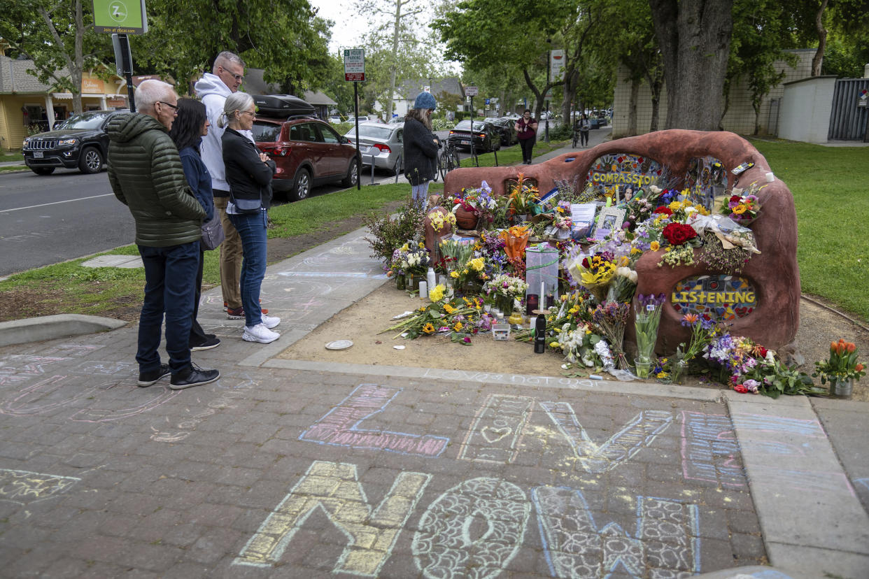 People view a memorial set up at the compassion bench in Davis, Calif., on Monday, May 1, 2023, to honor David Henry Breaux, 50 years old, who was found stabbed to death in Central Park. Residents of the Northern California university town are on edge after three people were stabbed within a week, including two fatally. (Paul Kitagaki Jr./The Sacramento Bee via AP)